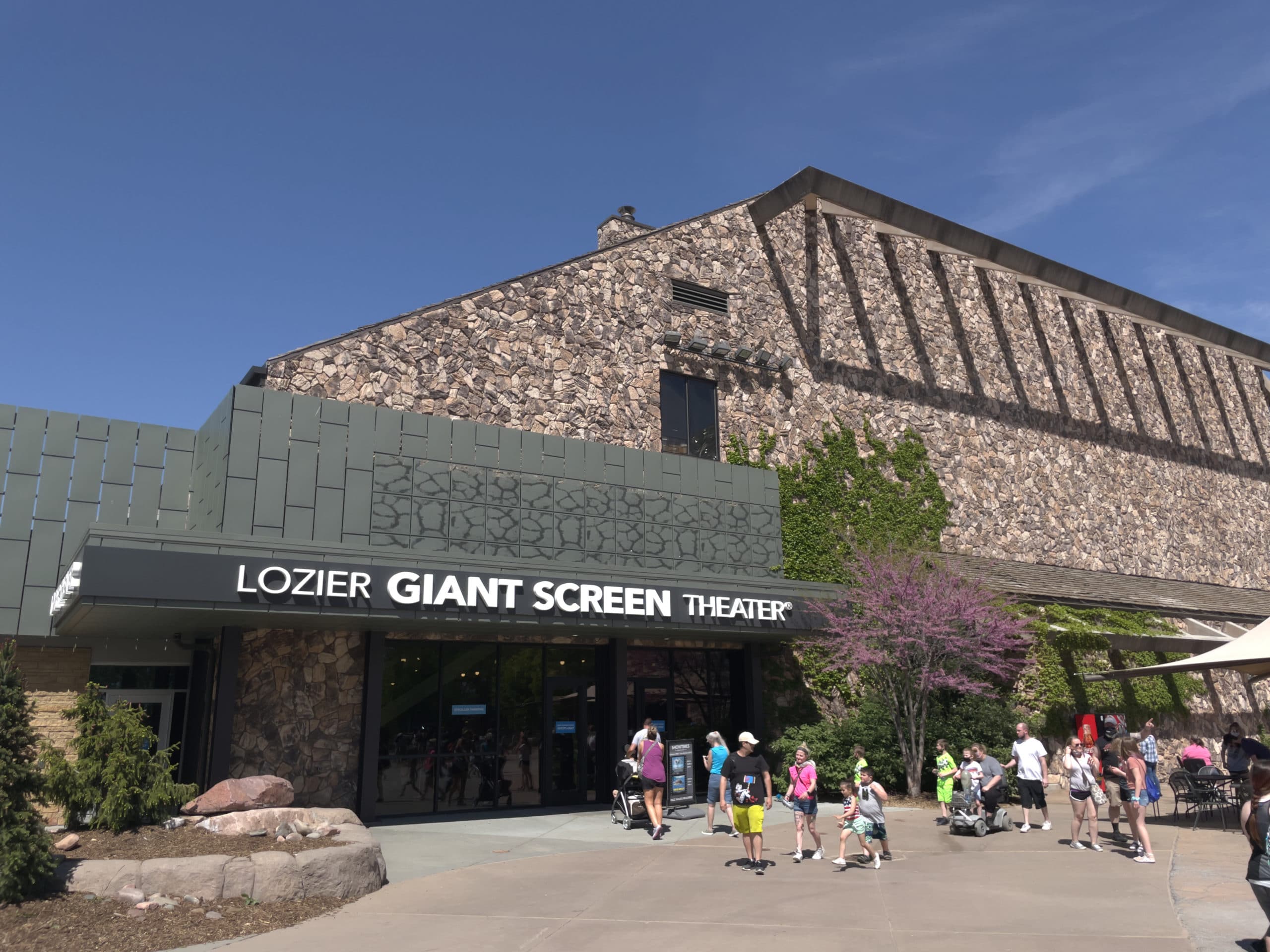 A large building with "Lozier Giant Screen Theater" on the sign. 