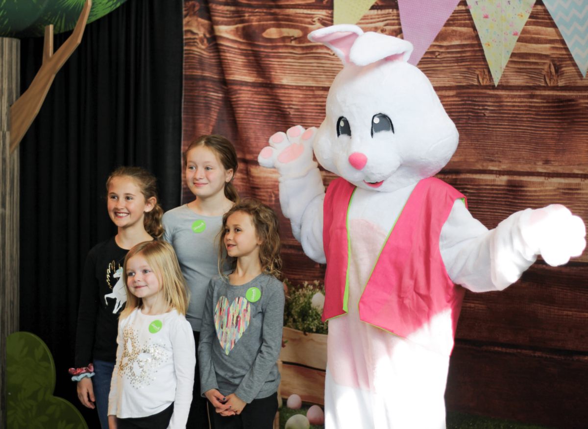 Easter bunny at the Children's Museum posing with children.